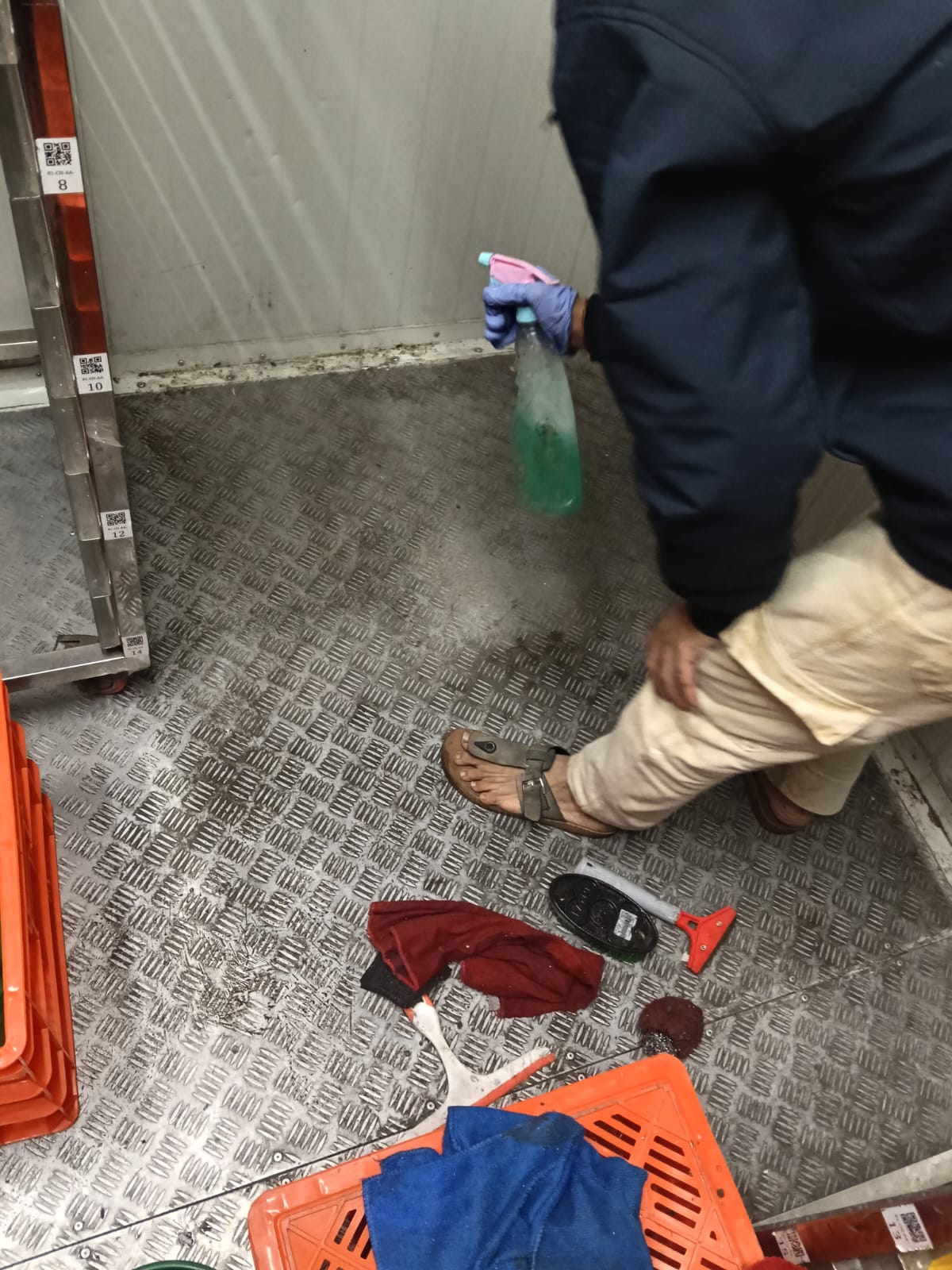 Before: grimy metal floor being pre-treated during deep cleaning