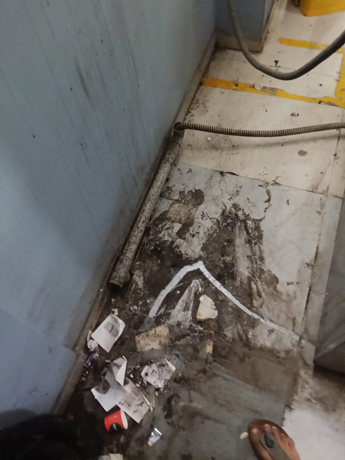 Before: dirty corner behind appliance with trash and grime